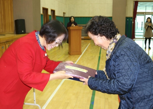 신입생 학용품 선물 받는 김풍자(오른쪽) 할머니[회인초등학교 제공]